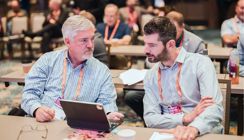 Two attendees connect and discuss business at the Show.