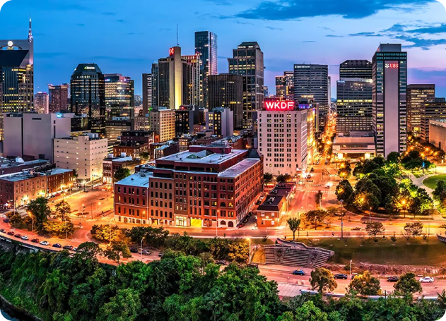 The Nashville skyline and downtown streets at dusk.