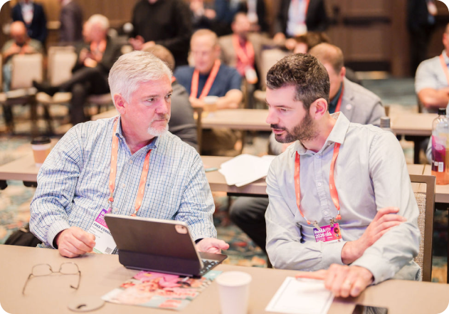 Attendees sharing a conversation around a table.